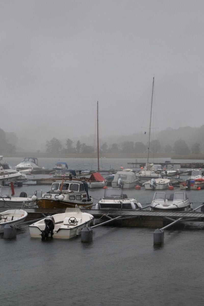 Marina with floating docks and rainy, foggy weather