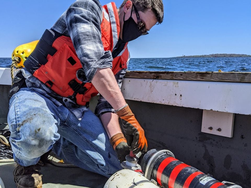 Toby Dewhurst of Kelson Marine adjusts load cell to measure drag on seaweed farm at St. Gelais